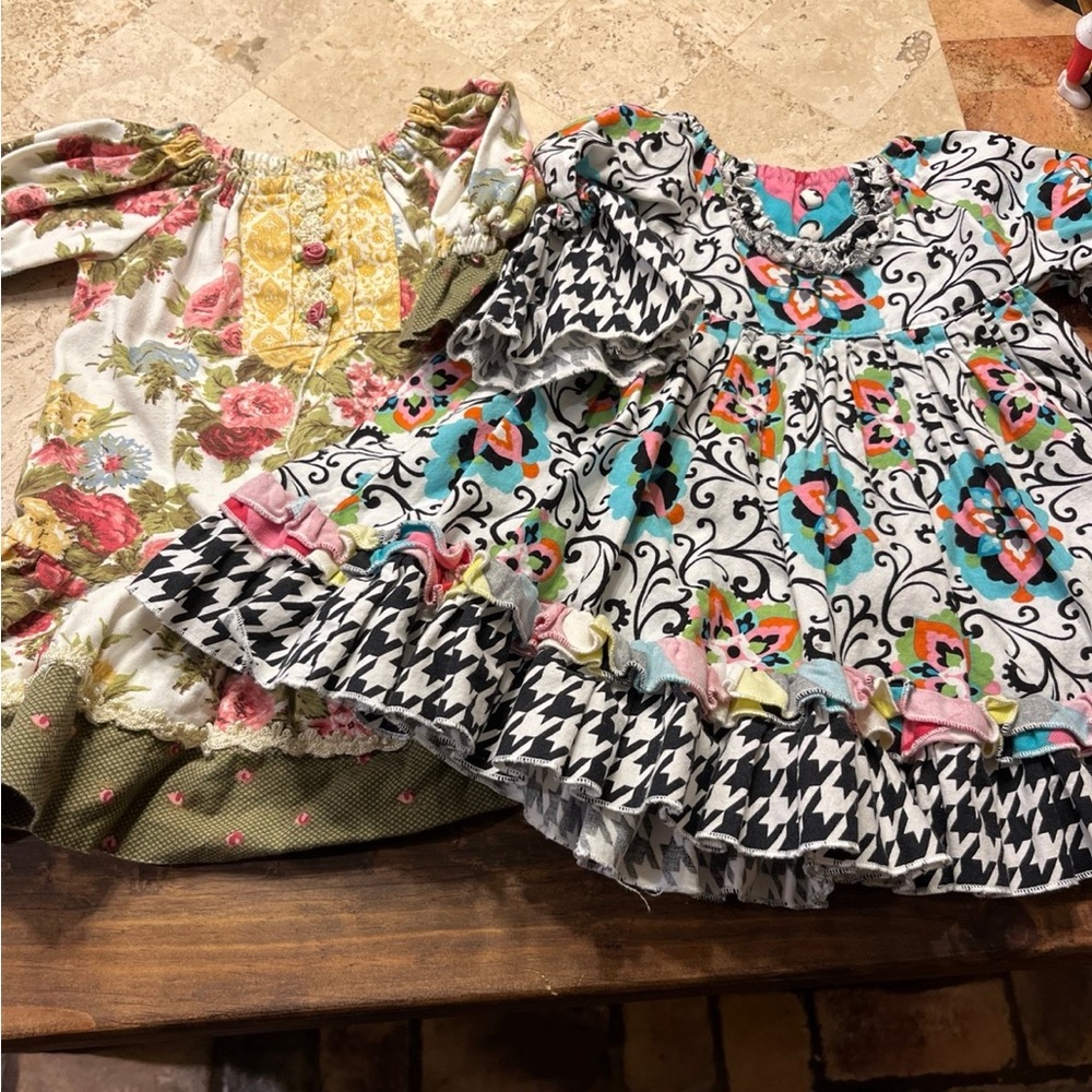 Two baby girl dresses, no size on them but an estimate would be 9-12 months